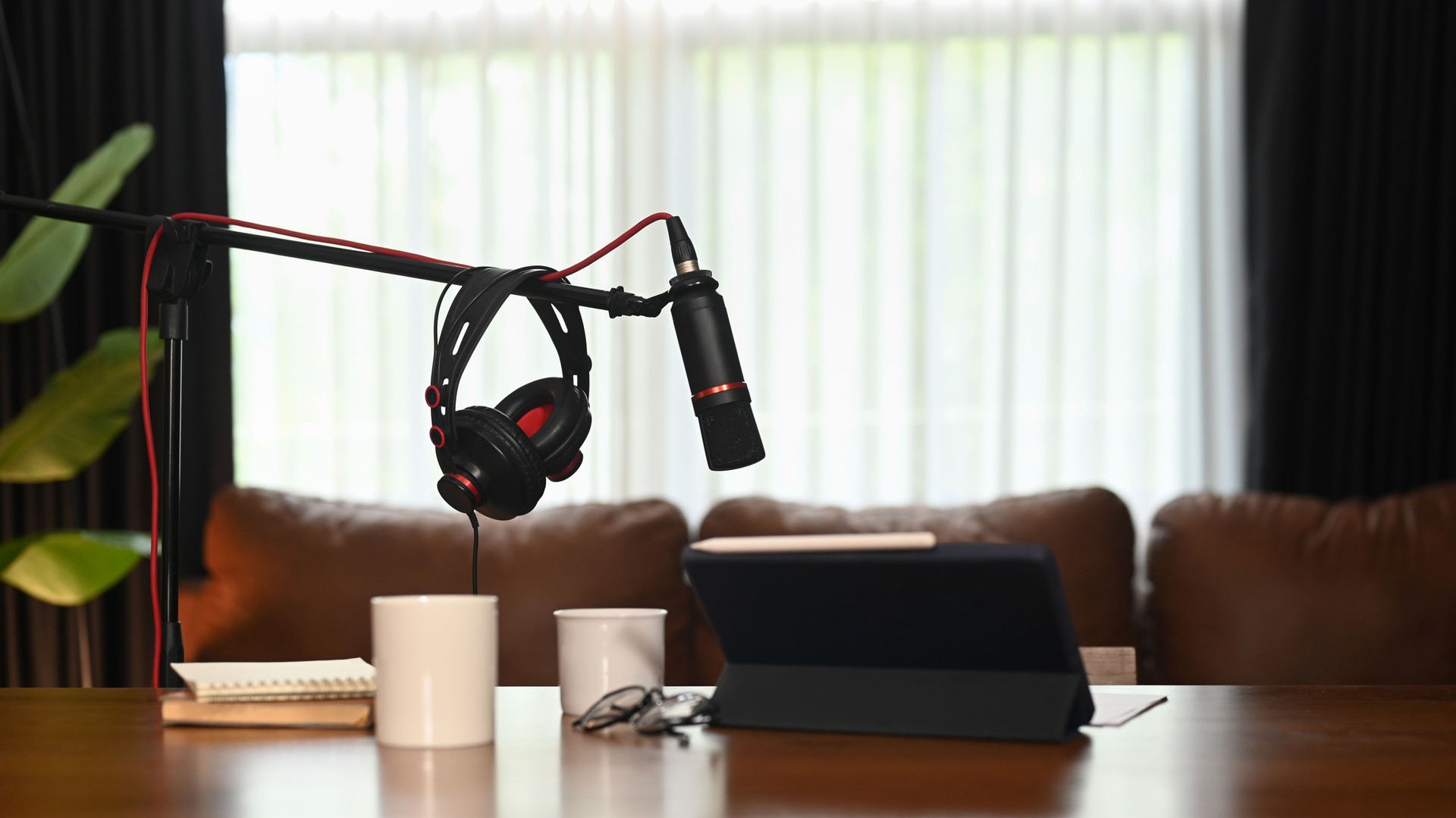 Professional condenser microphone, laptop and headphone. Entertainment, podcasts and technology concept.
